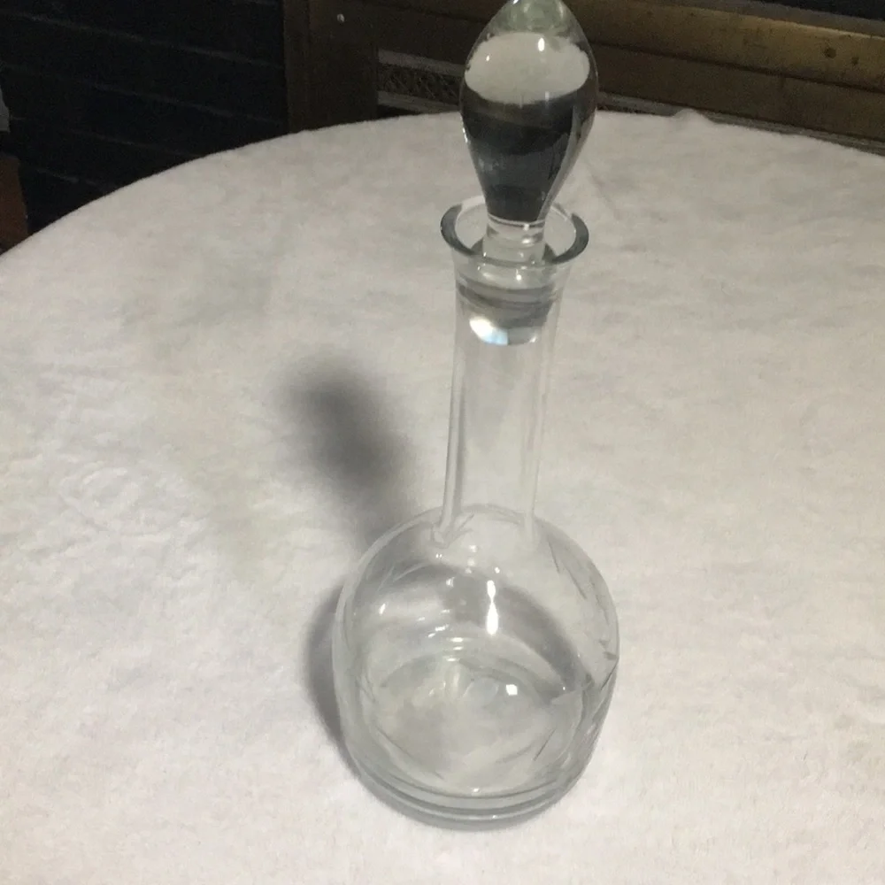 Floral etched glass decanter with stopper.